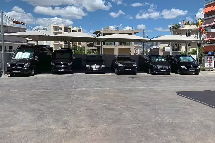 Modern black minivans ready for private transfer pickup, comfortable transport for Olympia full day tour