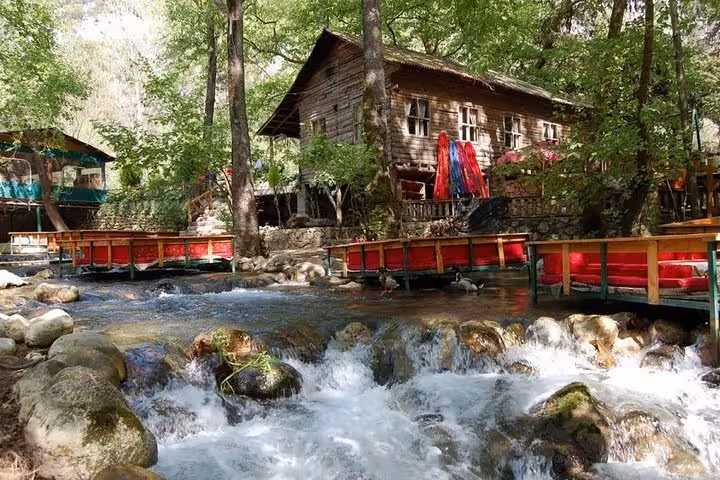 Riverside wooden lodge and rapids near Antalya on Olympos Teleferik Tahtali cable car day tour