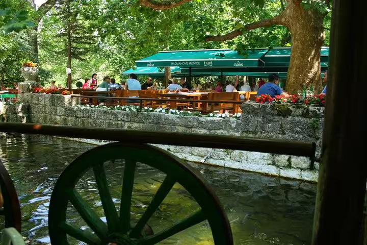 Waterwheel by Radmanove Mlinice restaurant, popular lunch stop on Omiš Cetina River boat tour from Makarska