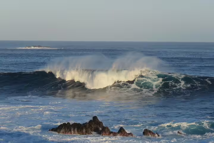 Majestic ocean waves crash against rocky shores in the stunning northwest of Madeira, perfect for an open roof 4x4 adventure.