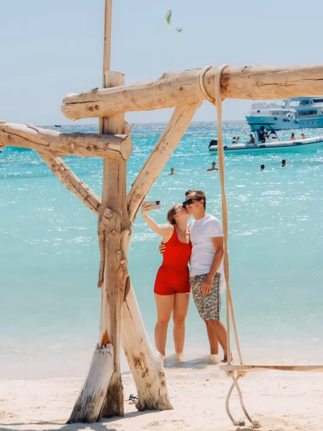 Couple taking a selfie on Orange Bay Island beach, Hurghada snorkeling boat trip with lunch and turquoise sea