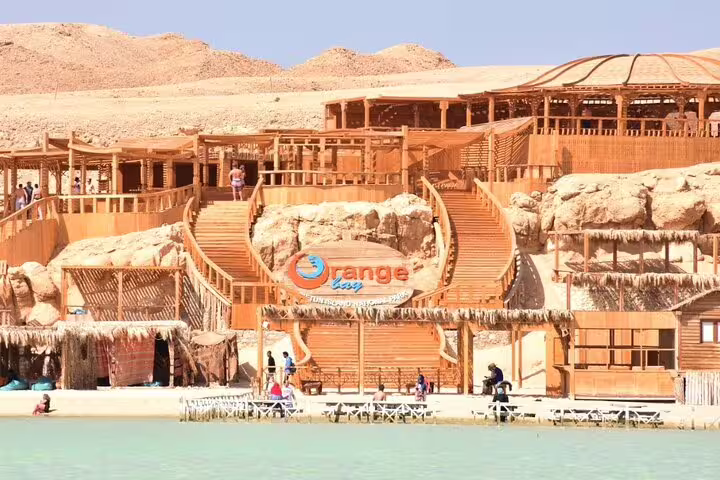Orange Bay Island wooden beachfront complex and steps by the sea, stop on Hurghada VIP snorkeling boat tour