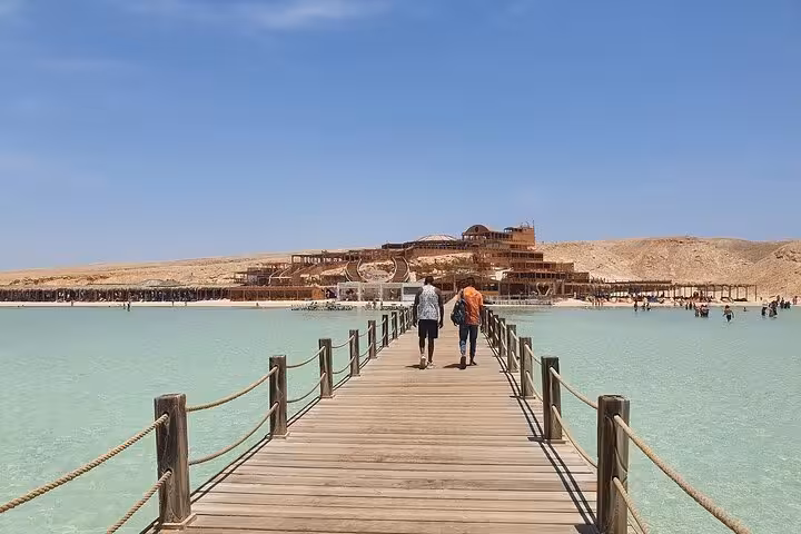 Wooden pier over turquoise water on Orange Bay Island, Hurghada sea trip stop for snorkeling and lunch