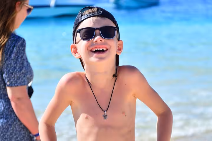 Happy child at Orange Bay beach, Hurghada, enjoying Orange Island sea trip with snorkeling and lunch