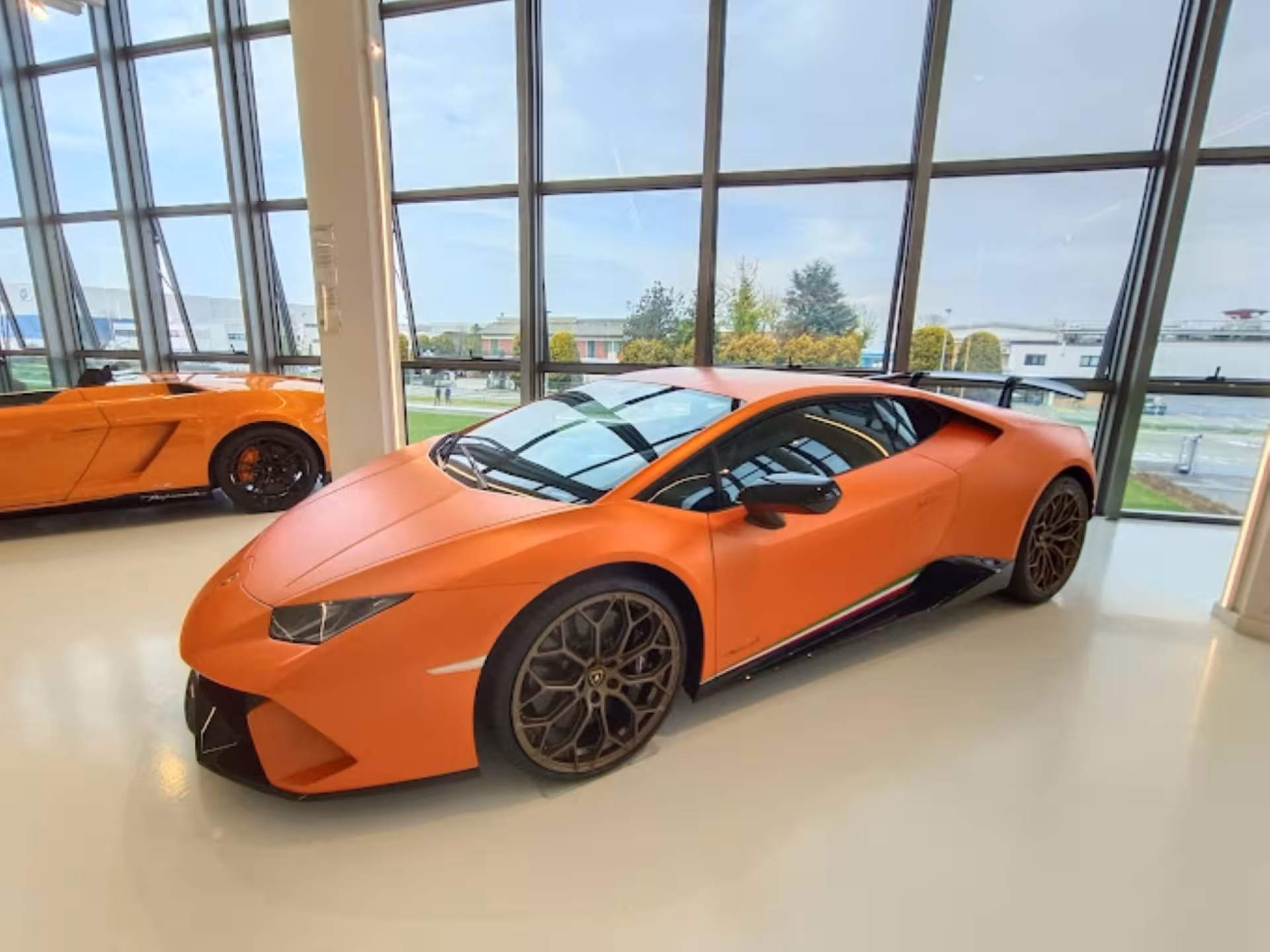 Orange Lamborghini Huracán showcased at Automobili Lamborghini Museum near Bologna, included in Ducati combo ticket