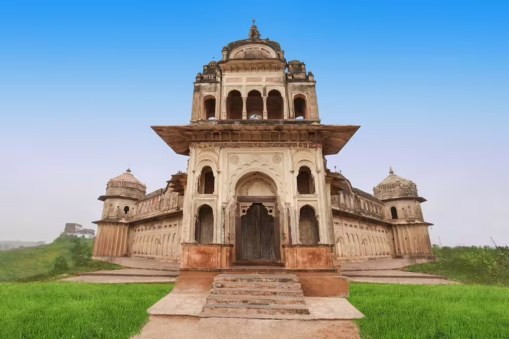 Explore the grandeur of Orchha's historic cenotaphs surrounded by lush greenery in Classical North India tour.