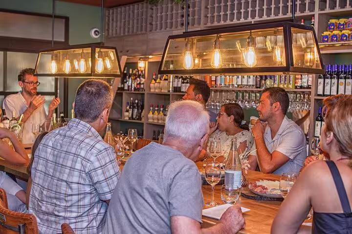 Group enjoying an organic wine tasting session in a cozy Nice wine bar with expert guidance.