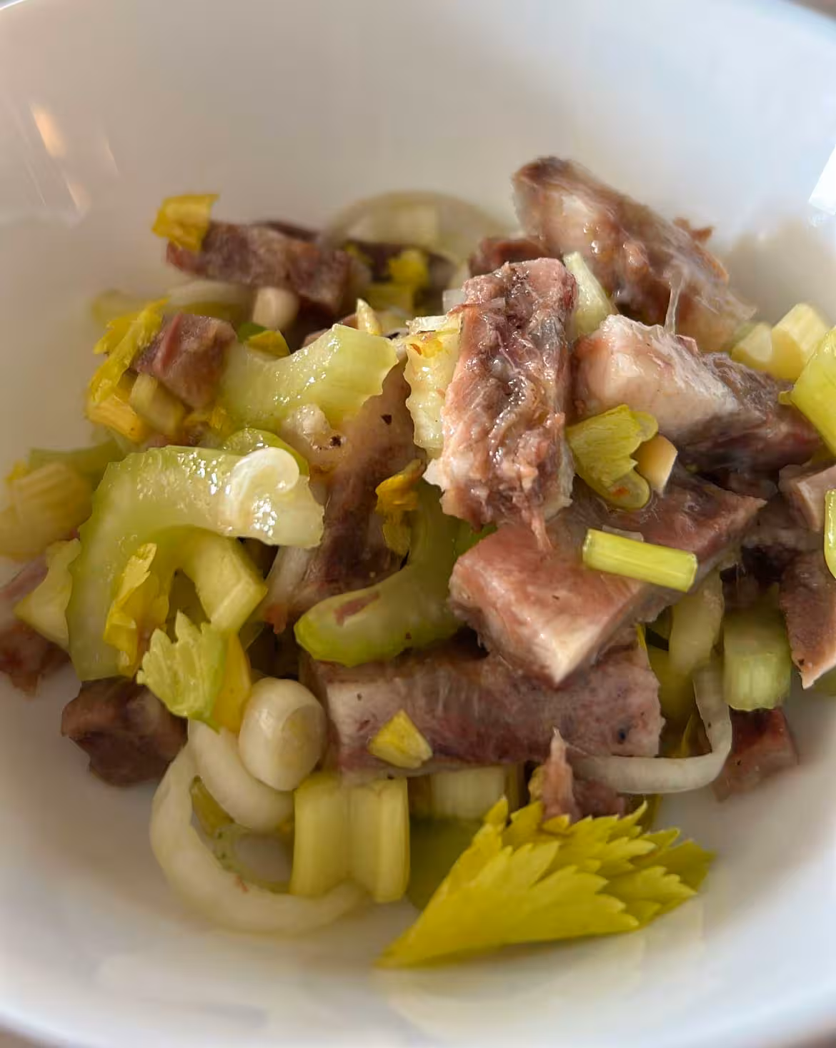 Enjoy a farm-fresh dish of tender meat with celery and onions during an Oristano olive oil tasting tour.