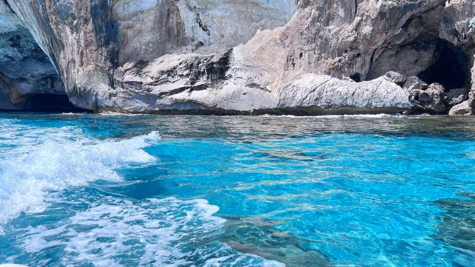 Discover the crystal-clear turquoise waters and rugged cliffs near Cala Goloritzè on a dinghy adventure.