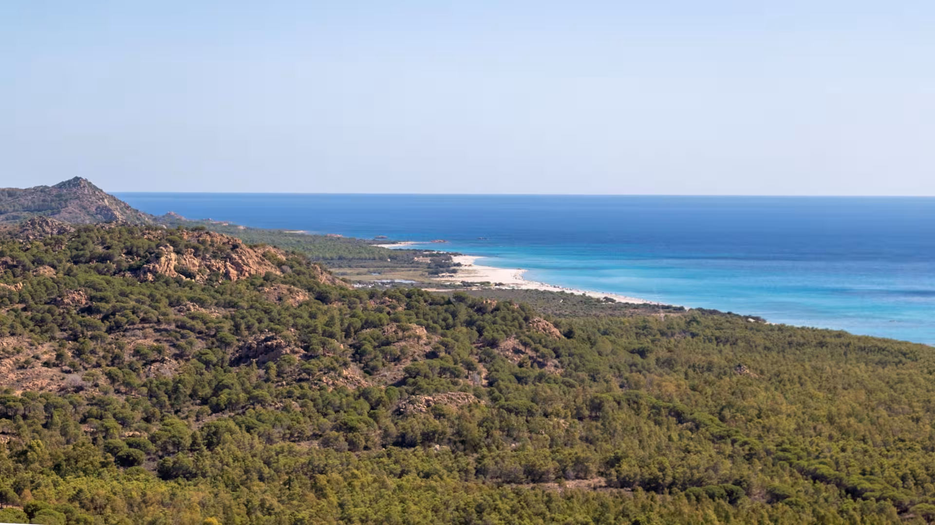 Aerial view of Biderosa's lush green landscape meeting the turquoise sea, ideal for a private Jeep tour from Orosei.