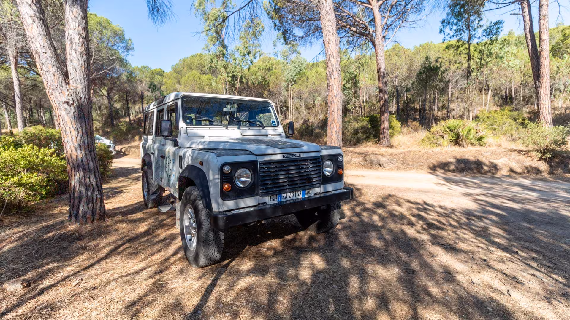 Jeep parked in a serene forest setting, ideal for a private tour adventure in Biderosa from Orosei.