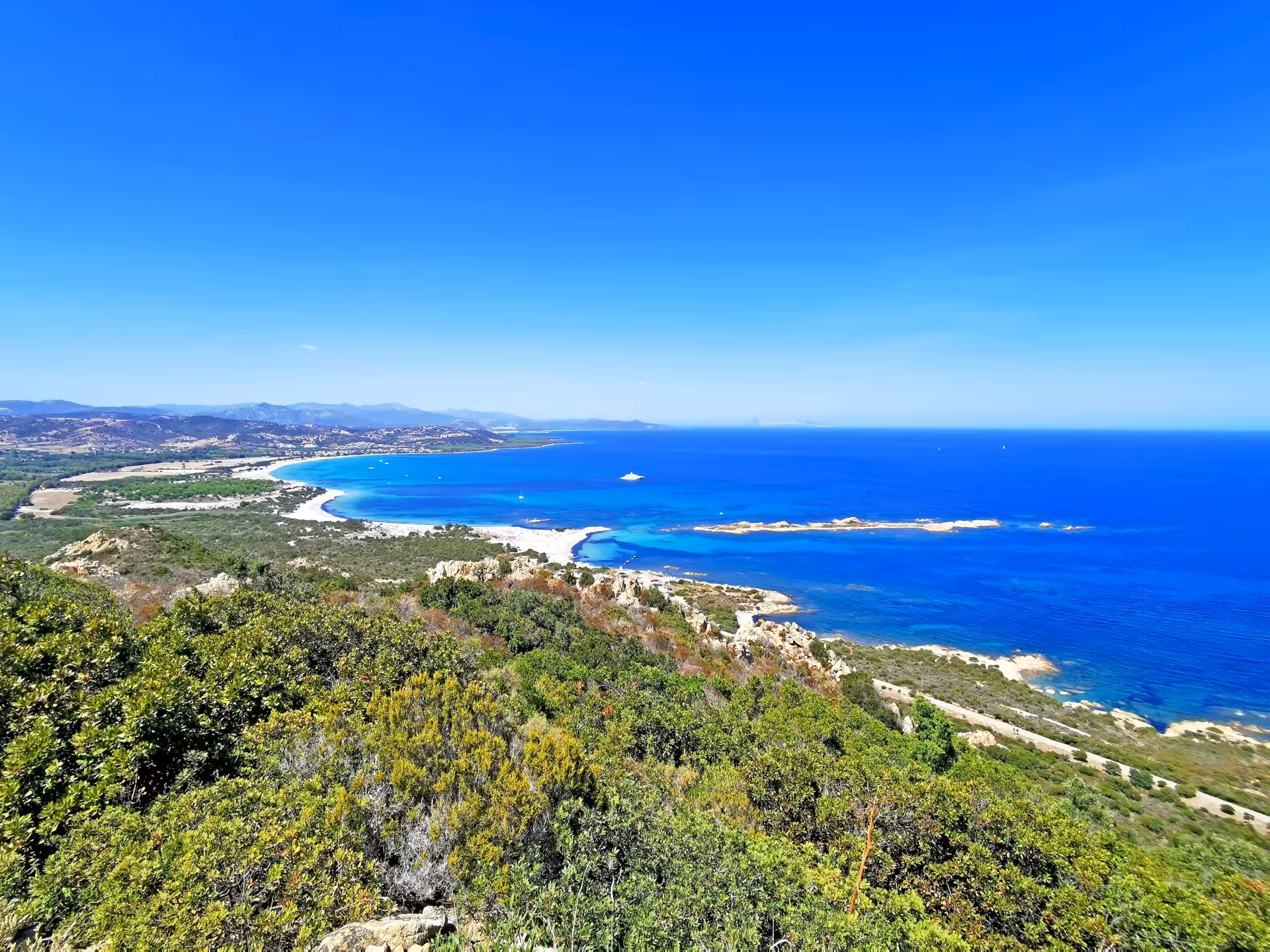 Panoramic view of Capo Comino's stunning coastline with vibrant blue waters, perfect for an Orosei Jeep adventure.