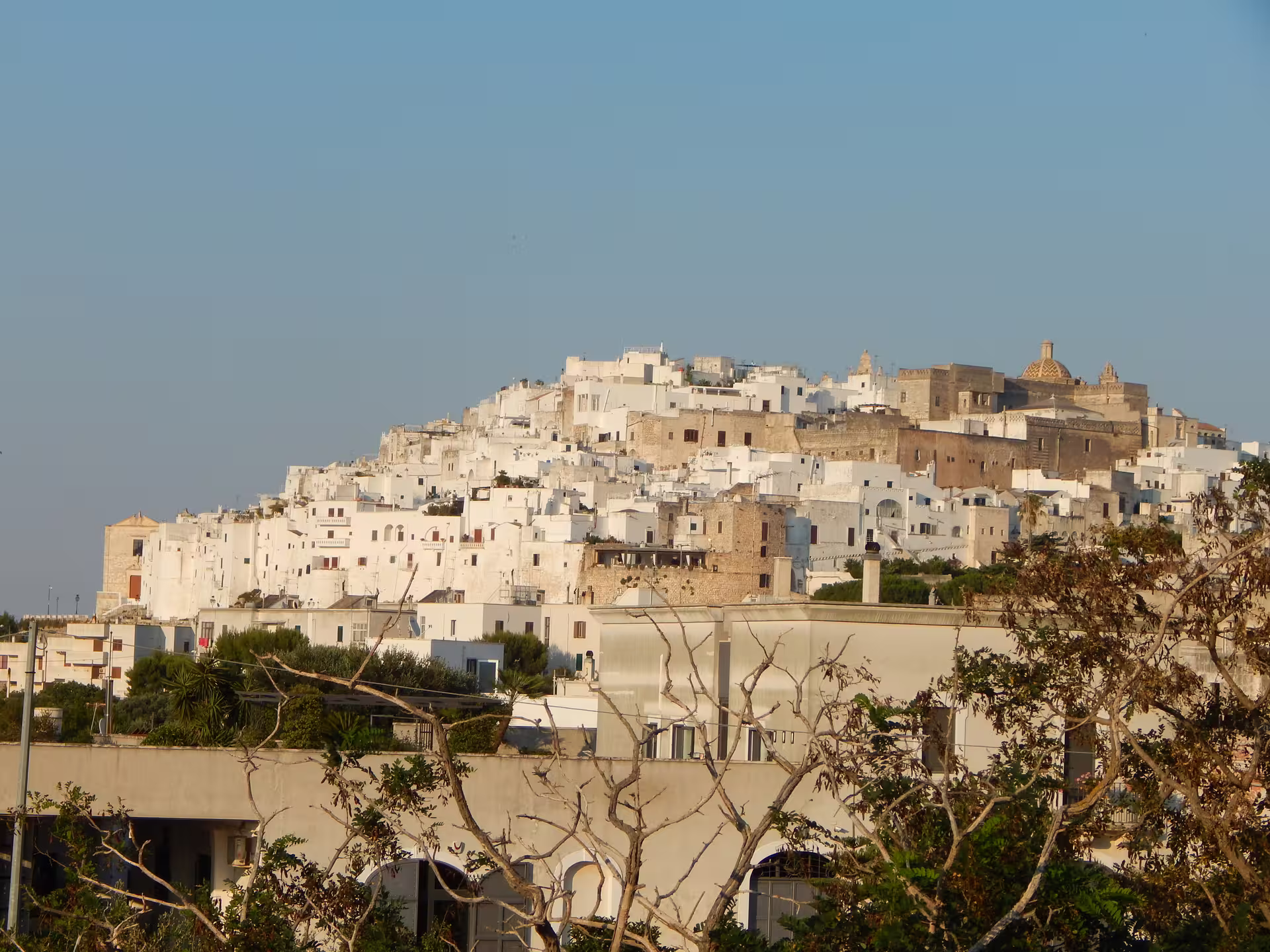 Panoramic view of whitewashed hilltop houses in Ostuni, the White City, on Enchanting Puglia self drive tour
