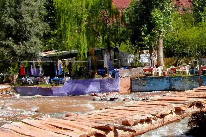 Riverside café with stone footbridge in Ourika Valley, Atlas Mountains day trip from Marrakech