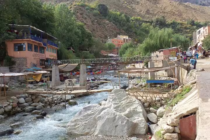 Ourika Valley riverside village with footbridge and cafes, Atlas Mountains day trip from Marrakech Morocco