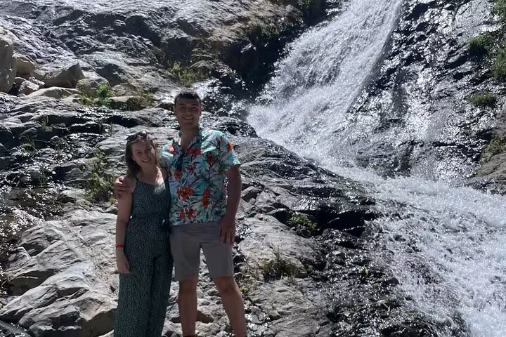 Travelers by Ourika Valley waterfall in the Atlas Mountains on a day trip from Marrakech to Berber villages