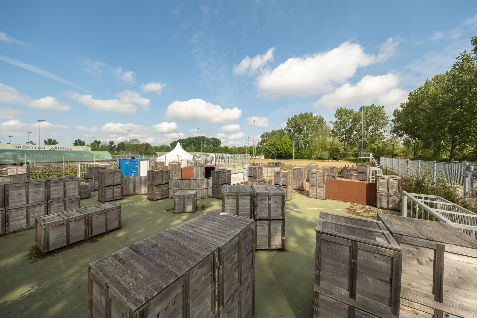 Outdoor laser tag arena in Amsterdam with wooden barricades and obstacles, ideal for group games and parties