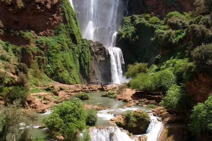 Ouzoud Waterfalls cascades into emerald pools, a highlight of a private day trip from Marrakech, Morocco