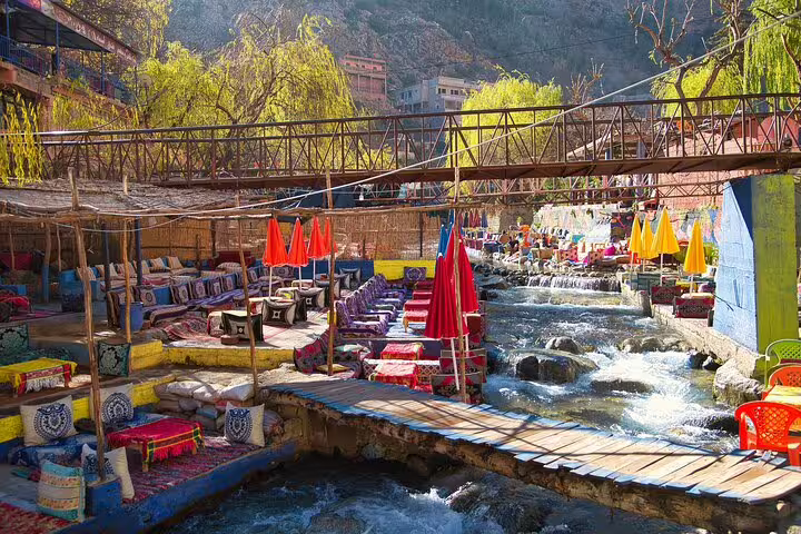 Riverside cafes and footbridge near Ouzoud Waterfalls, a highlight of the Marrakech day trip to Ouzoud cascades