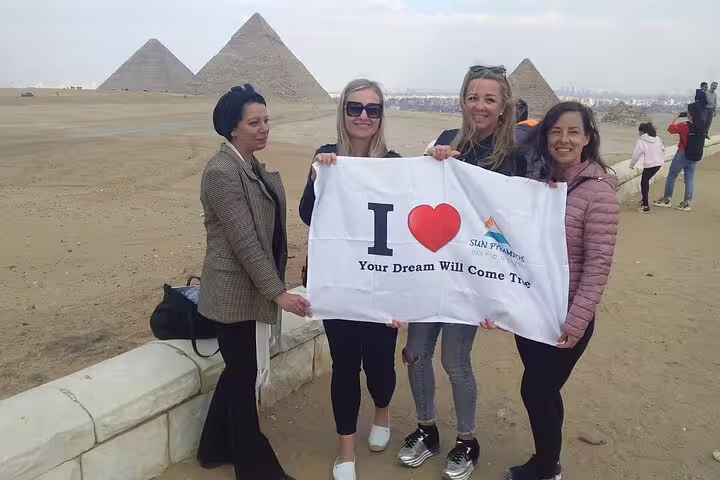 Travelers at Giza Pyramids on Cairo tour from Luxor by VIP first class overnight train, Egypt
