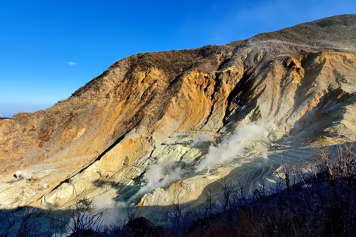 Dramatic volcanic landscape of Owakudani in Hakone with smoke vents, ideal stop on a Mt. Fuji guided tour.