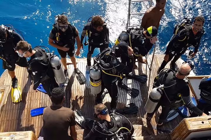 PADI Open Water Course boat deck briefing in Hurghada with divers gearing up for Red Sea training dives