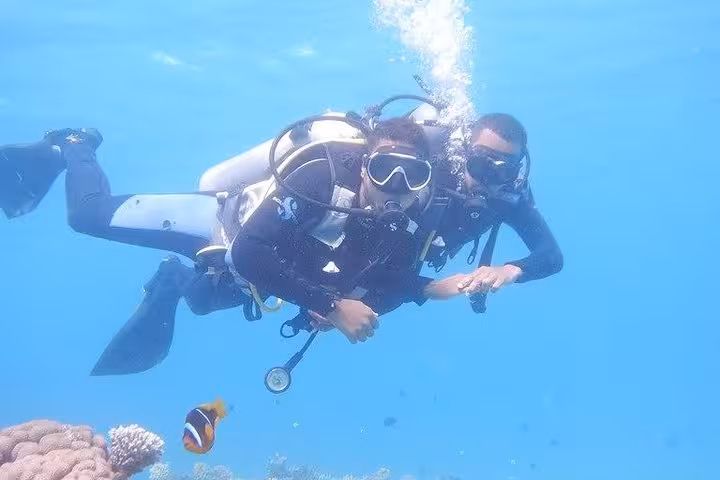 PADI Open Water Course in Hurghada with instructor guiding student diver over Red Sea coral reef