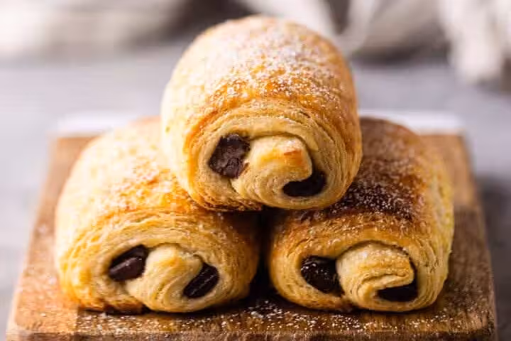 Indulge in flaky pain au chocolat pastries on the Discover Paris Flavors tour in Le Marais.