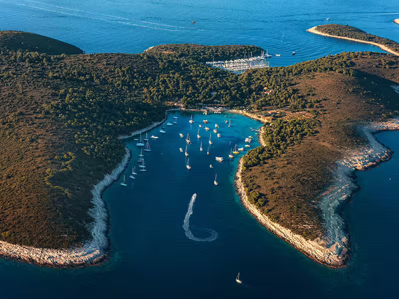 Aerial of Pakleni Islands bay with sailboats and turquoise water, perfect for swimming on a private boat tour