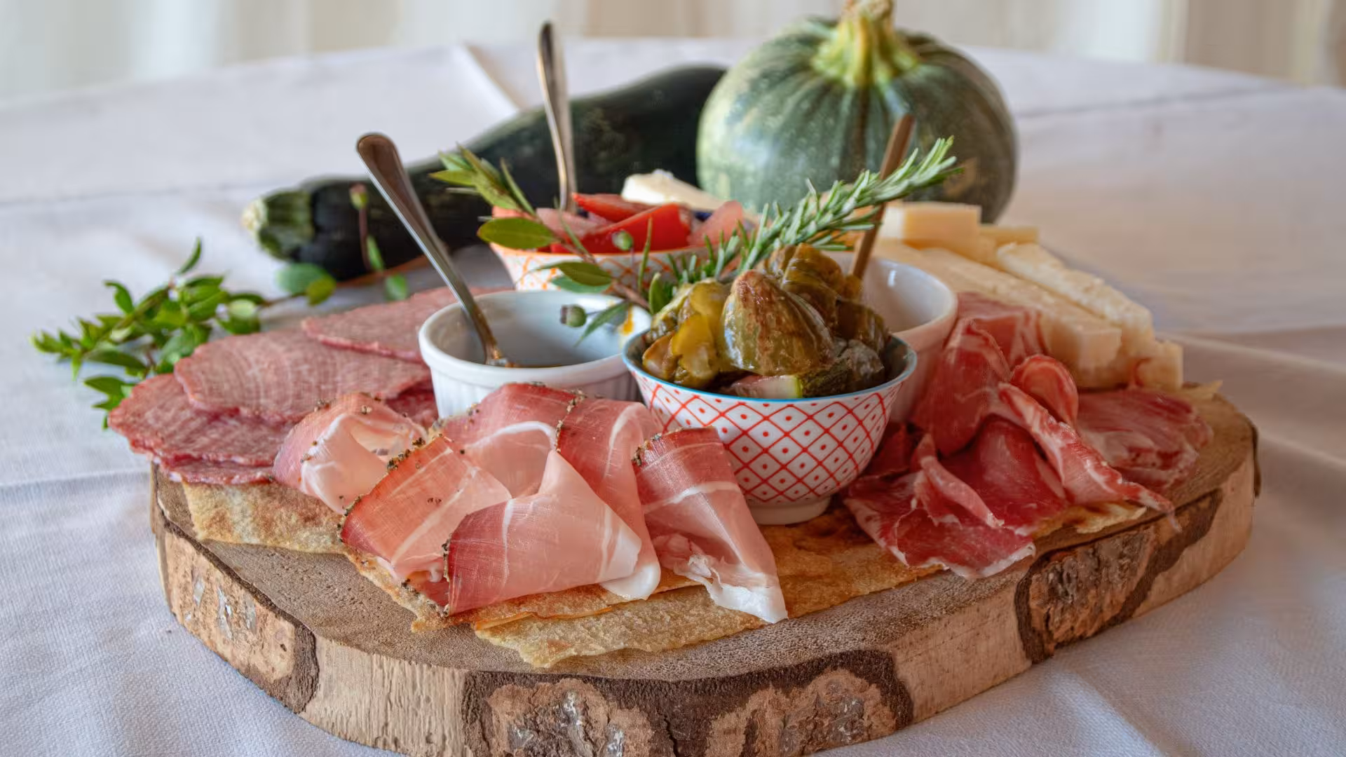 Close-up of a charcuterie board with meats and cheeses at a Gallura winery in Palau, showcasing local specialties.
