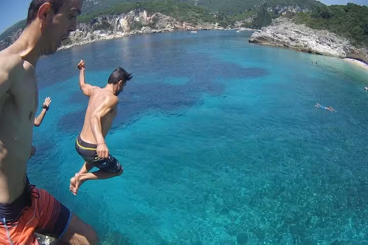Cliff jump into turquoise waters at Paleokastritsa bay on a private Corfu beaches tour to Glyfada