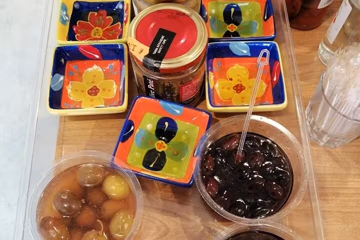 Corfu local tastings with olives and traditional spreads on the Paleokastritsa private tour experience
