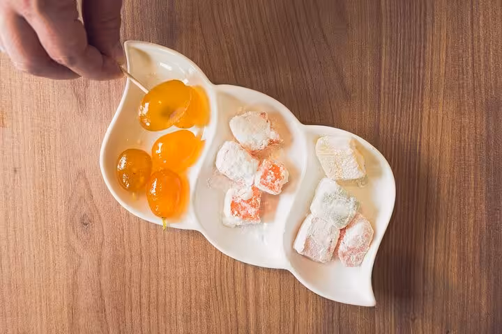 Traditional Corfu kumquat sweets and local treats served on a tasting plate during a Paleokastritsa private tour