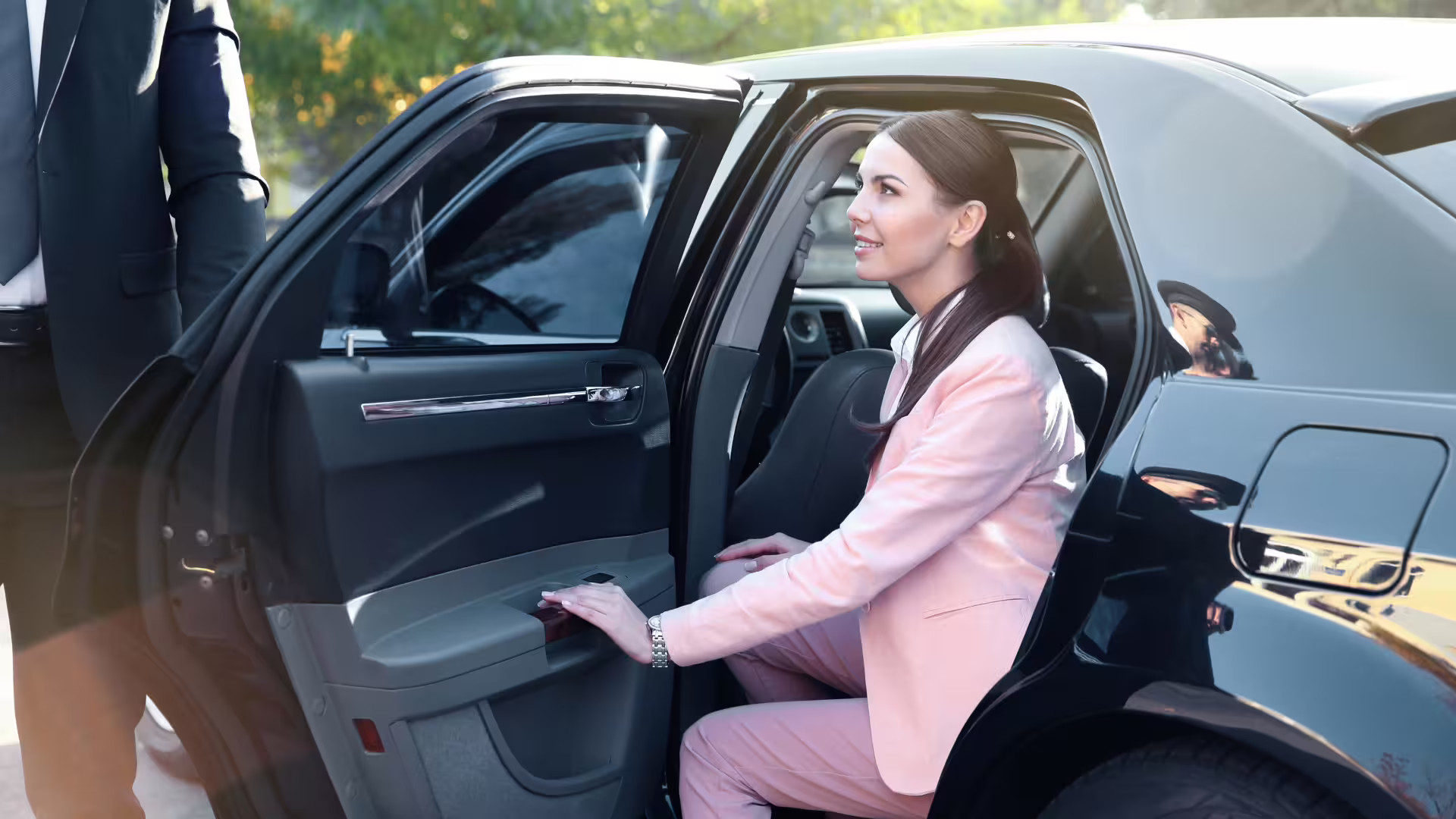 Business traveler stepping out of a luxury private car for Palermo Airport to Grand Hotel Wagner transfer service