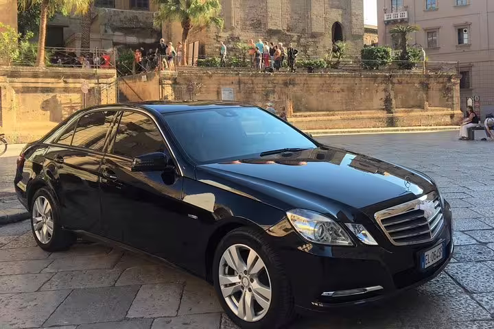 Black executive sedan used for private transfer service between Palermo Airport PMO and San Vito Lo Capo historic center