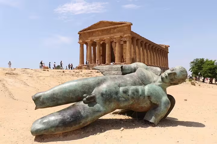 Ancient Greek temple and fallen bronze statue in Agrigento’s Valley of the Temples, destination of Palermo airport transfer