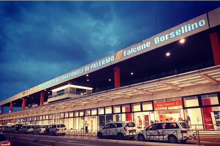 Evening view of Palermo Falcone Borsellino Airport terminal, starting point for private transfer to Best Western Ai Cavalieri Hotel