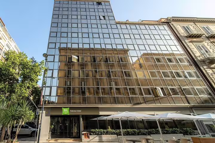 Modern glass-fronted ibis Styles Palermo Cristal hotel exterior, arrival point for private airport transfer service