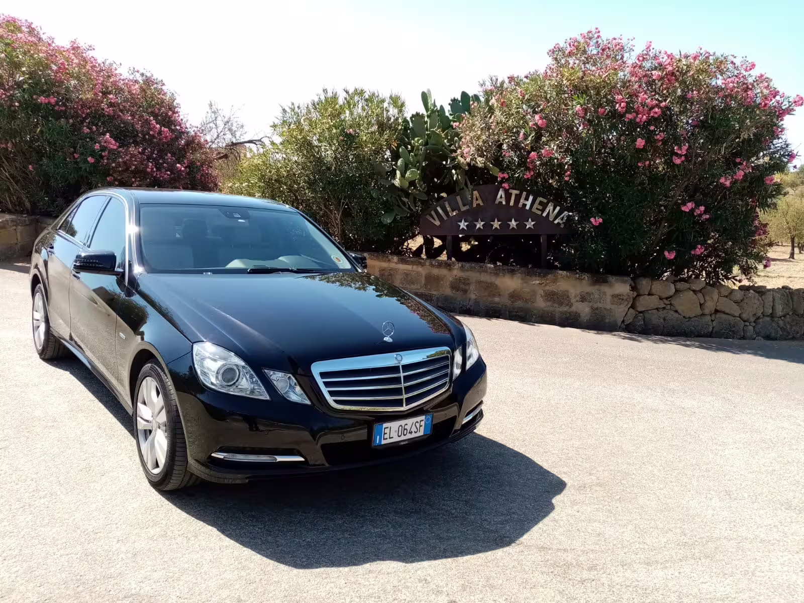 Executive black Mercedes sedan waiting outside Villa Athena for private Palermo airport to Verdura Resort transfer in Sciacca