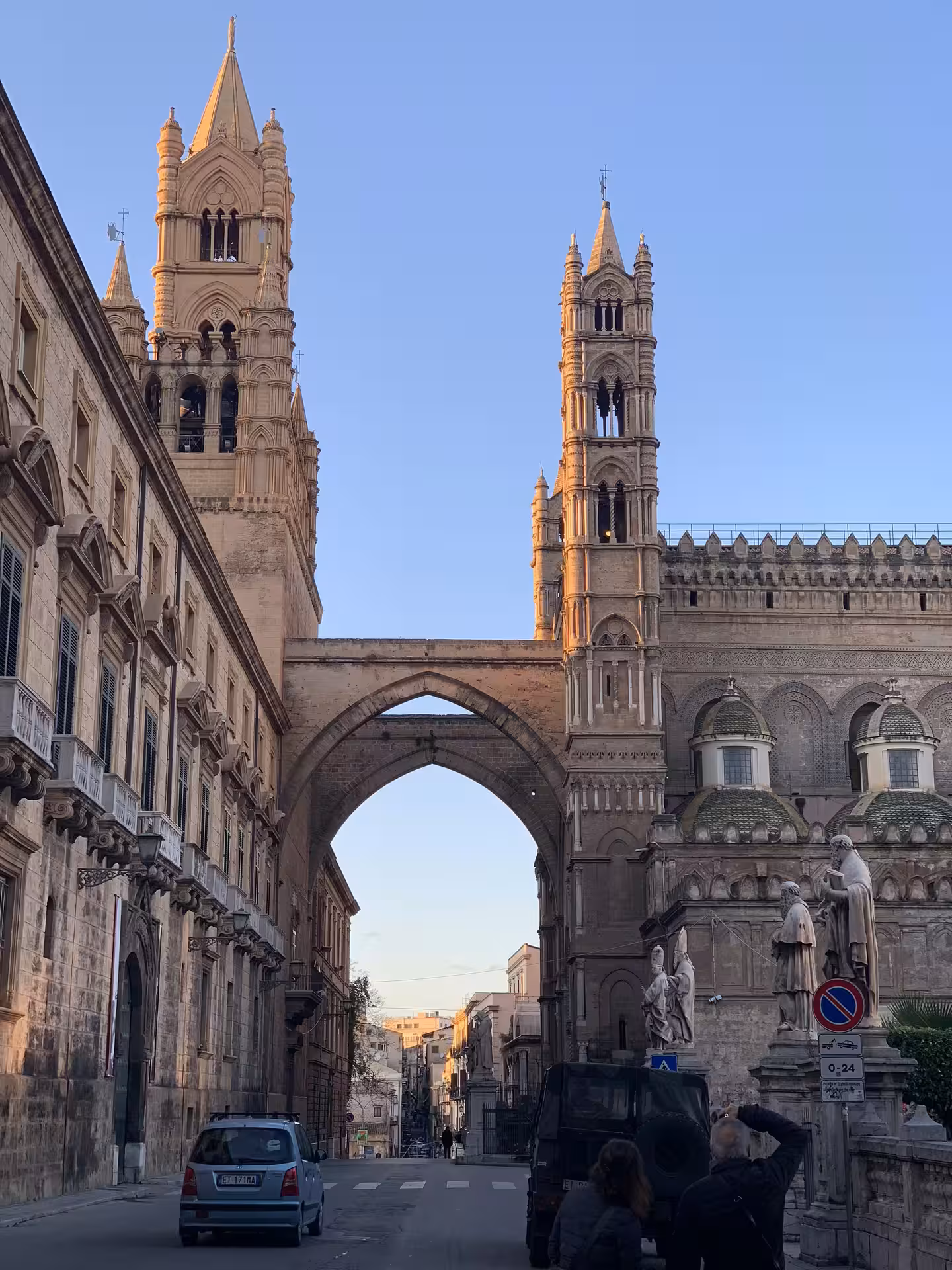 Sunlit façade and twin bell towers of Palermo Cathedral seen from the street on a Monreale and Monte Pellegrino tour