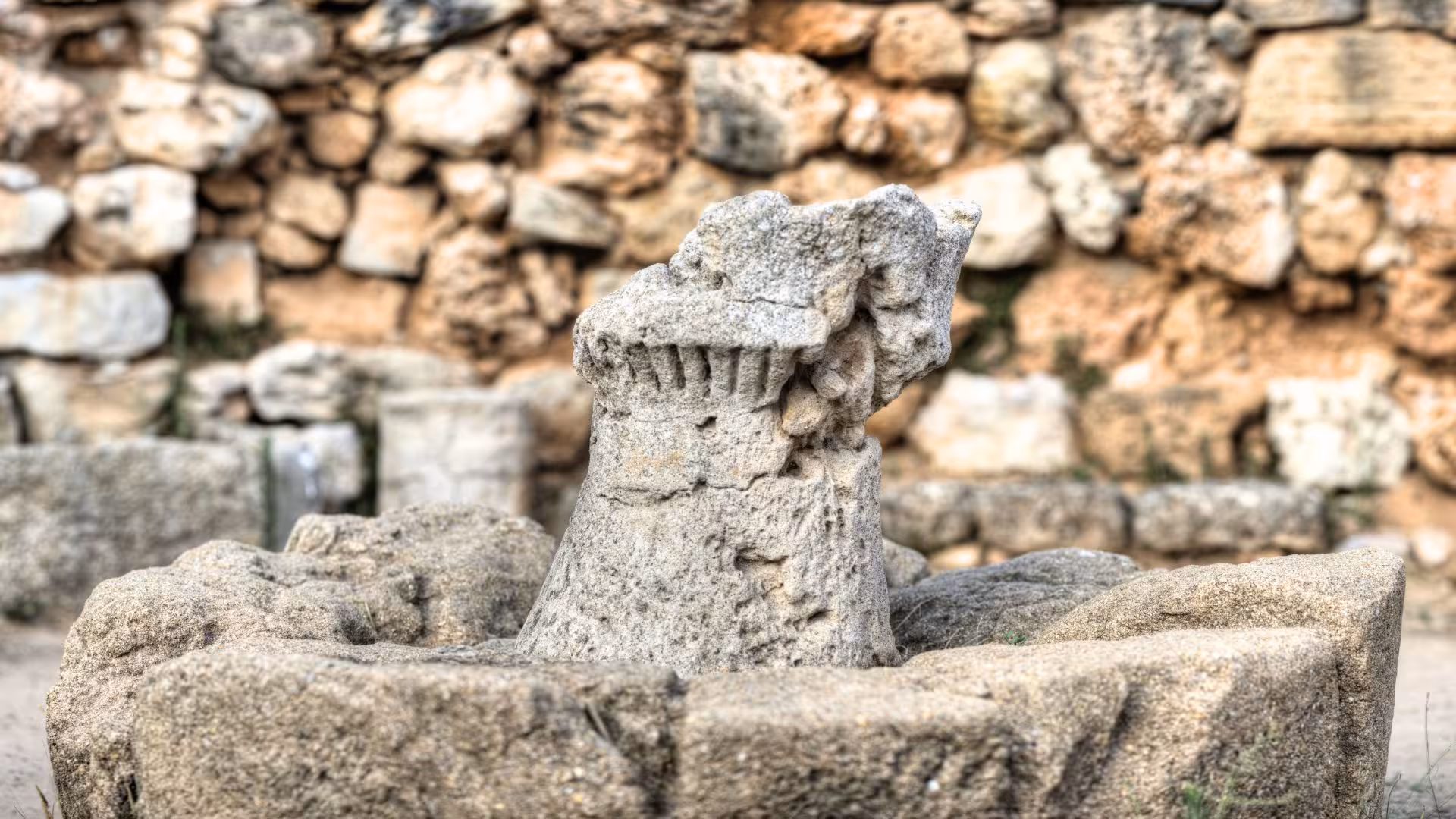 Close-up of ancient stone structure at Palmavera Nuraghe in Alghero, showcasing intricate historical architecture.