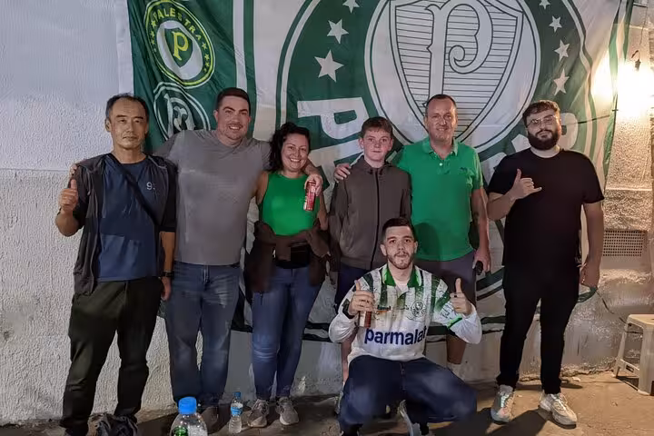 Group photo with Palmeiras flag in São Paulo on Palmeiras Game Experience with Local, pre-match fan meetup