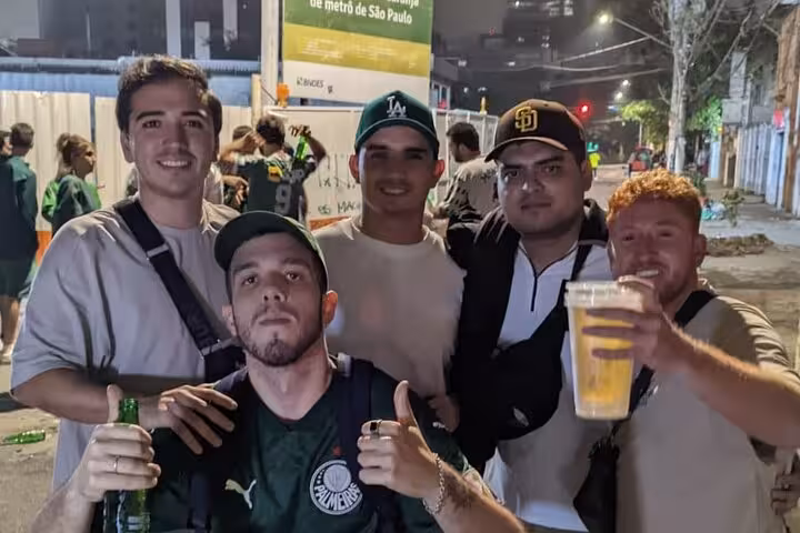 Group of Palmeiras supporters with drinks outside São Paulo metro before match on local guided game experience