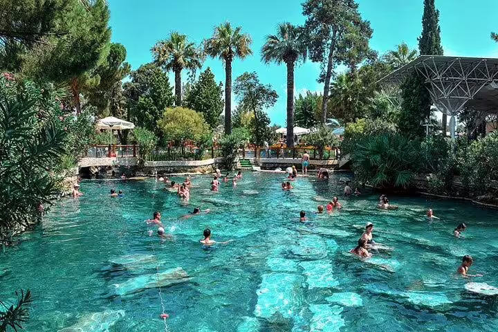 Relax in the thermal pools of Pamukkale surrounded by lush greenery on a unique day tour from Kusadasi and Selcuk.