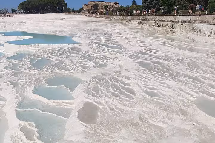 White travertine terraces and thermal pools at Pamukkale, highlight of the 2 day Ephesus Aphrodisias tour