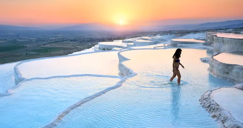 Sunset at Pamukkale travertine terraces with thermal pools, highlight of the 9-day Turkey tour itinerary