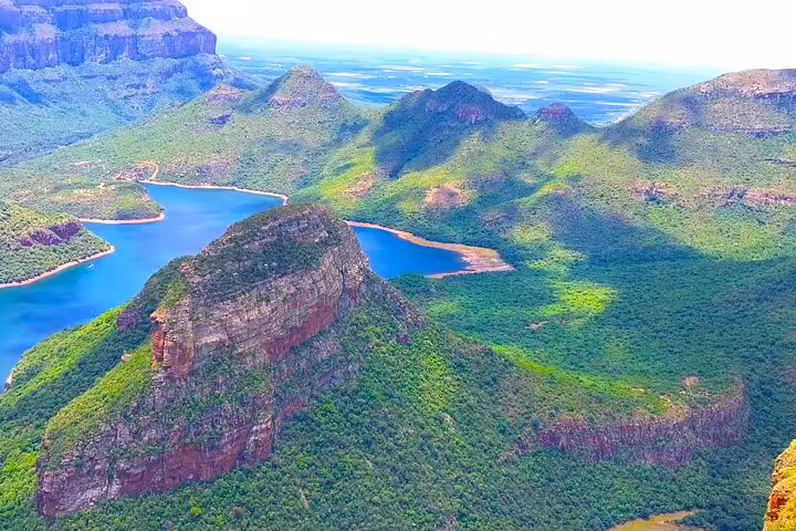 Stunning aerial view of lush green mountains and serene blue lakes on the Panorama Guided Experience tour.