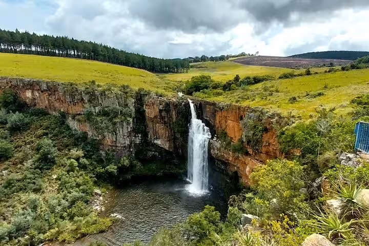 Breathtaking waterfall amidst vibrant landscapes, a highlight of the Panorama Guided Experience tour.