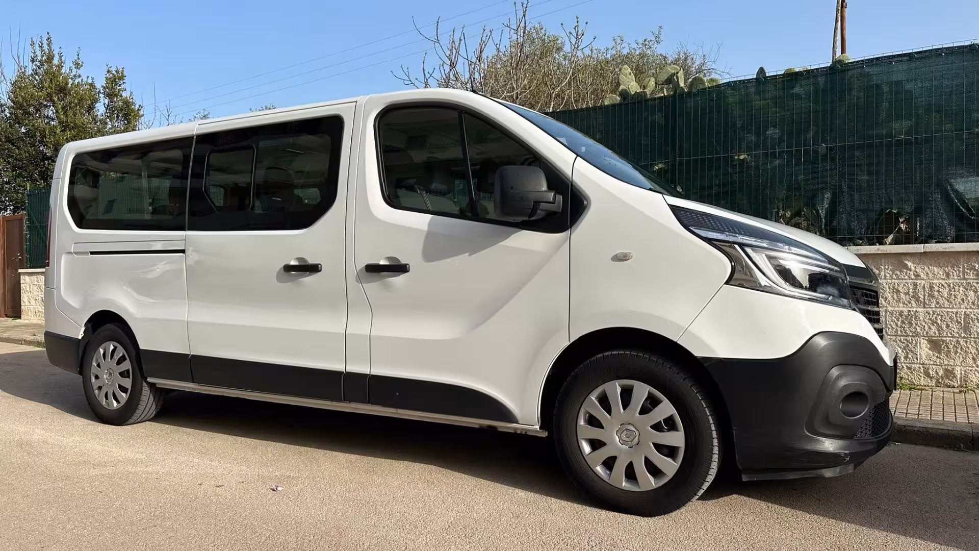 Comfortable white tour van ready for the panoramic journey from Alghero to Bosa, ensuring a smooth ride.