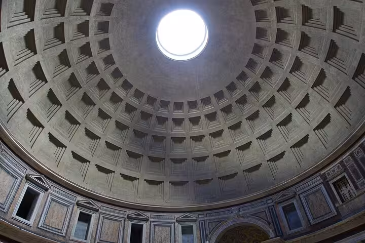View of the Pantheon's iconic oculus and coffered dome illuminated by natural light.
